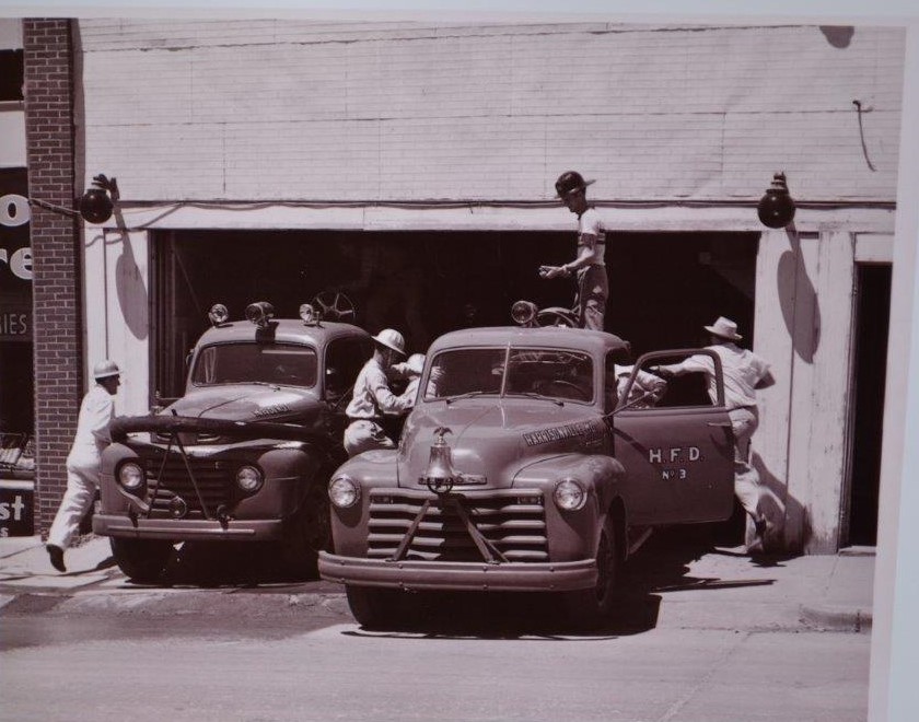 Older image of the Fire Fighters Working on Vehicles at the Fire Station